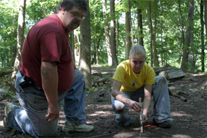 Jim and Caitlin take depths below datum measurements to ensure recording the amount of soil removed from a layer