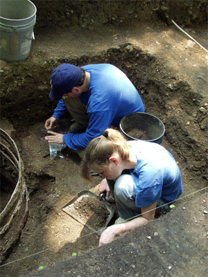 Dr. Sam shows one of our volunteers, Bridget, the nuances of a barrel cistern construction.